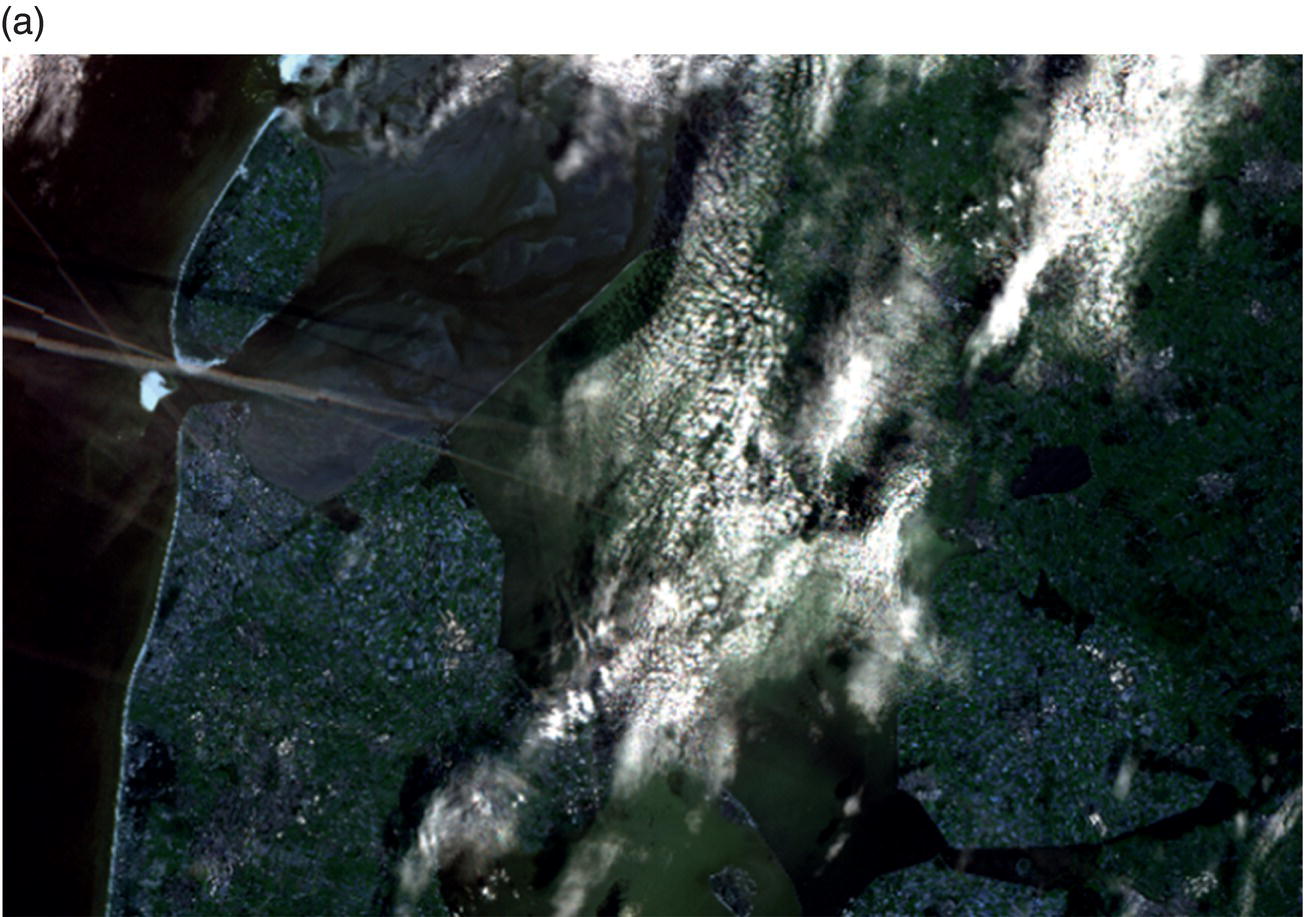 An aerial image shows a landscape with fields, roads, and a body of water. The scene is partially covered by scattered clouds, with shadows visible on the ground. A prominent river or canal runs through the center, intersected by a large bridge or road.