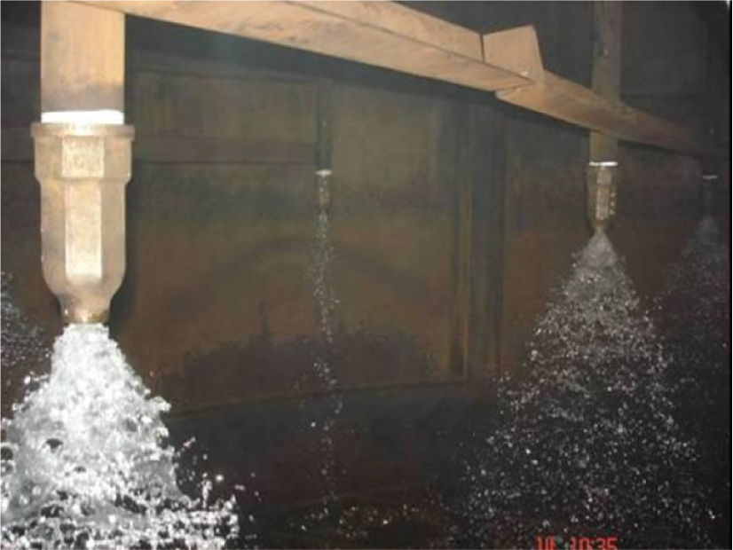A photographic image of distilled water distribution through plugged nozzle.