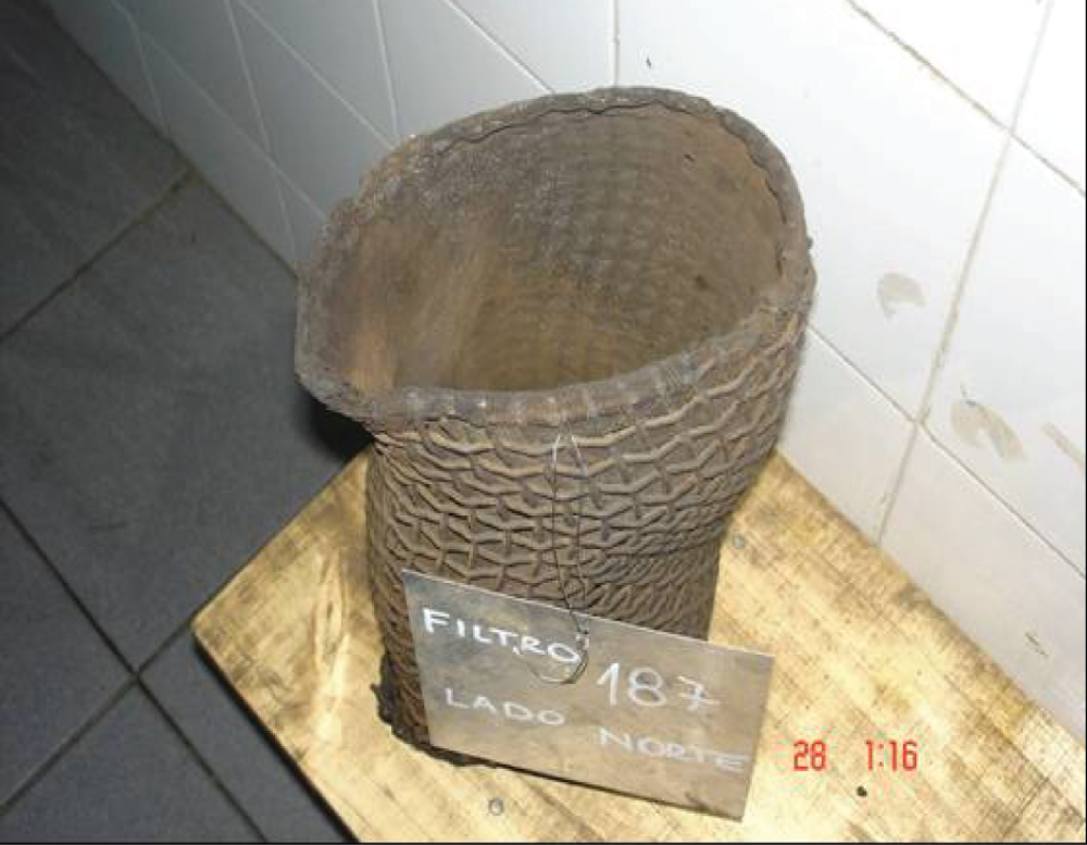 A photograph of a deformed mesh screen that was taken from a Y-strainer. Y-strainers are used to filter solids from liquids or gases.