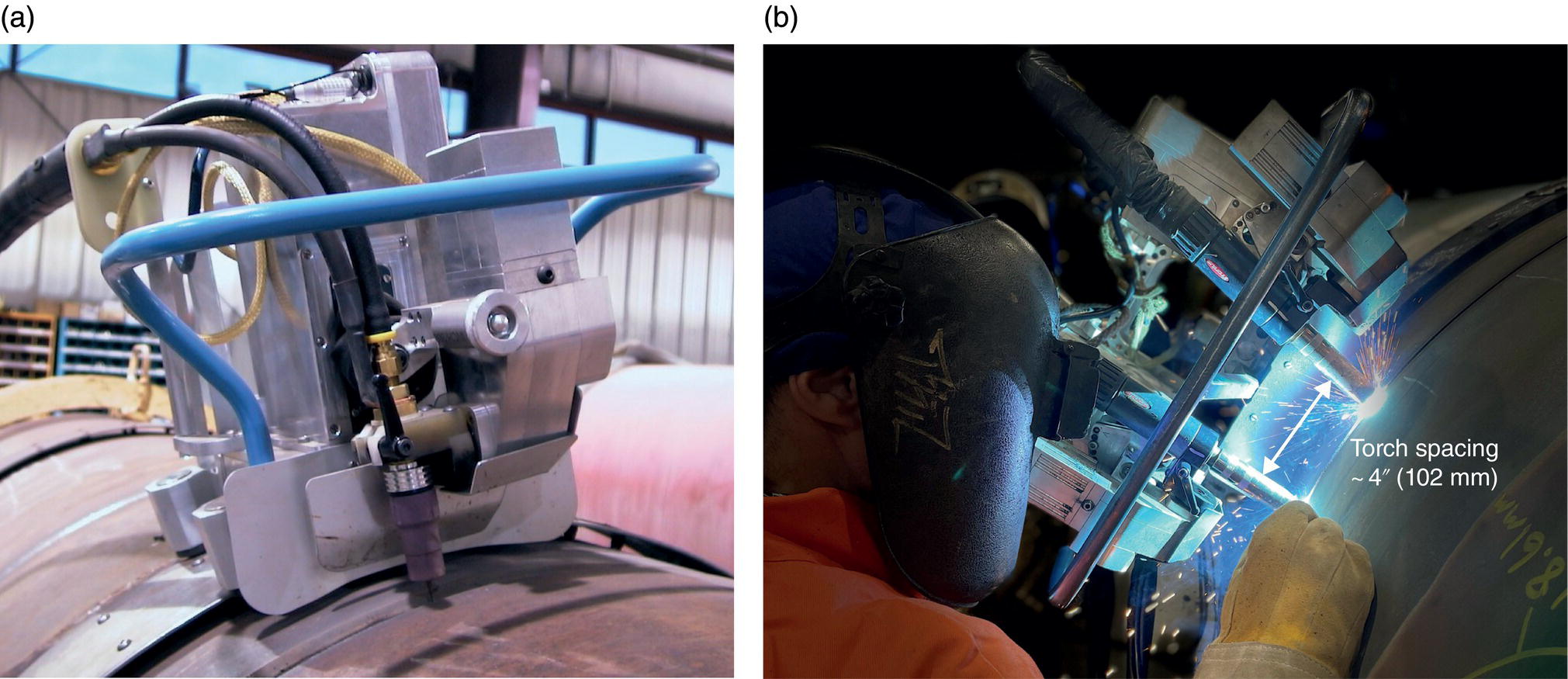 Two photographs. a. Close-up of a machine attachment on a pipeline, showing mechanical parts and cables. b. A person in protective gear performing welding on a pipeline, with sparks visible. The text reads Torch spacing 4, 102 millimeters.