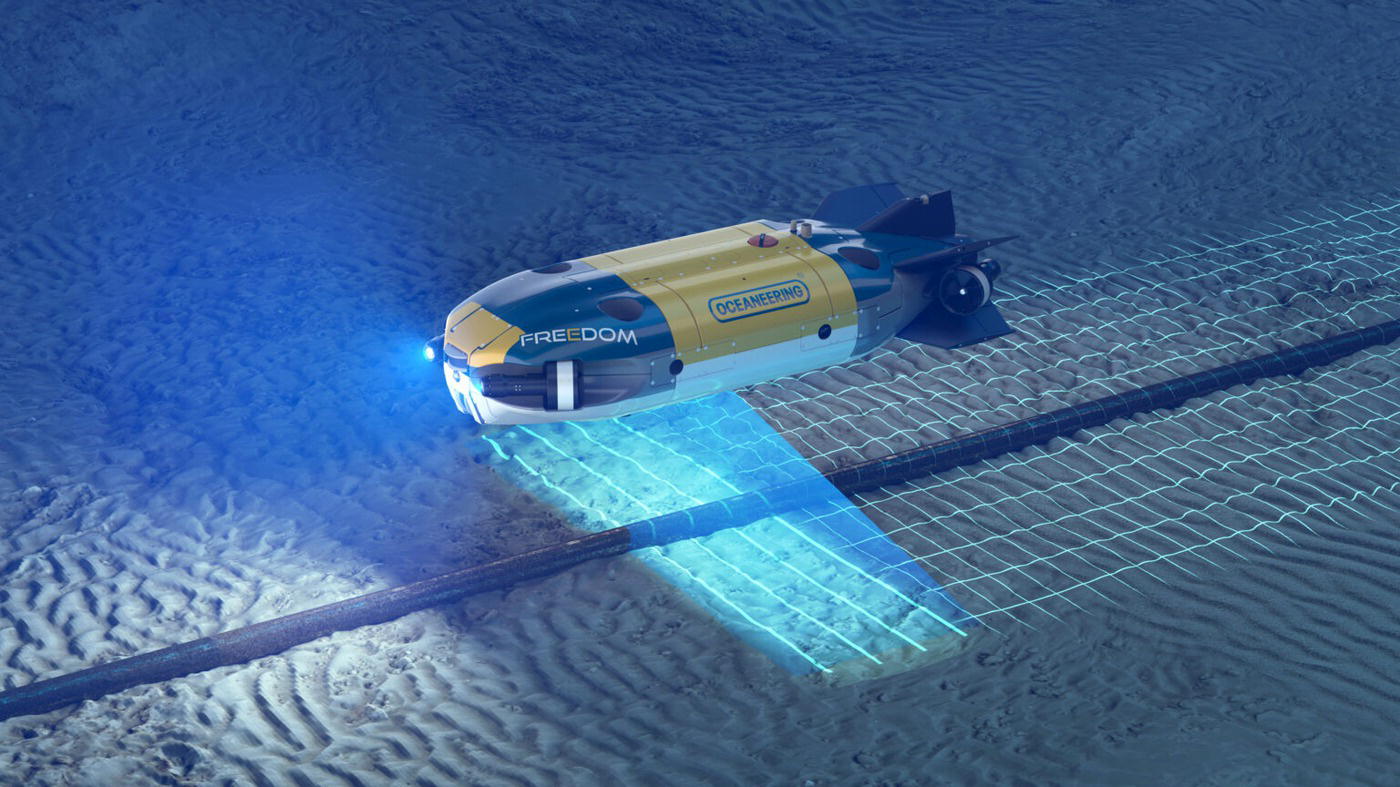 A submersible named Freedom navigates through the ocean floor, equipped with advanced technology. Its design features a streamlined body, with prominent lights illuminating the seabed. The environment reveals patterned sandy textures, indicating movement and activity. A grid pattern appears on the ocean floor, likely generated from the submersible’s scanning or mapping capabilities. The surrounding space is dark, emphasizing the bright lights and the contours of the terrain, creating a sense of exploration and discovery in the deep sea.