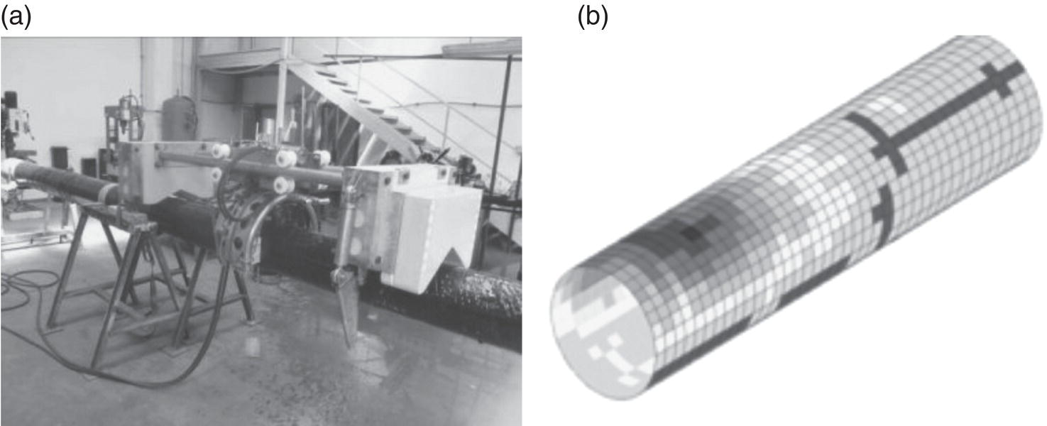 A laboratory setting features a large cylindrical apparatus mounted on a stand, equipped with mechanical components for a research or testing application. The foreground focuses on a complex device connected to the cylinder, with various tubes and wires extending from it. In the background, a staircase leads to an upper level. Adjacent to this, a three-dimensional graphic representation portrays a cylindrical object composed of a grid pattern, with variations in shading and texture, suggesting intricate design elements or data visualization.