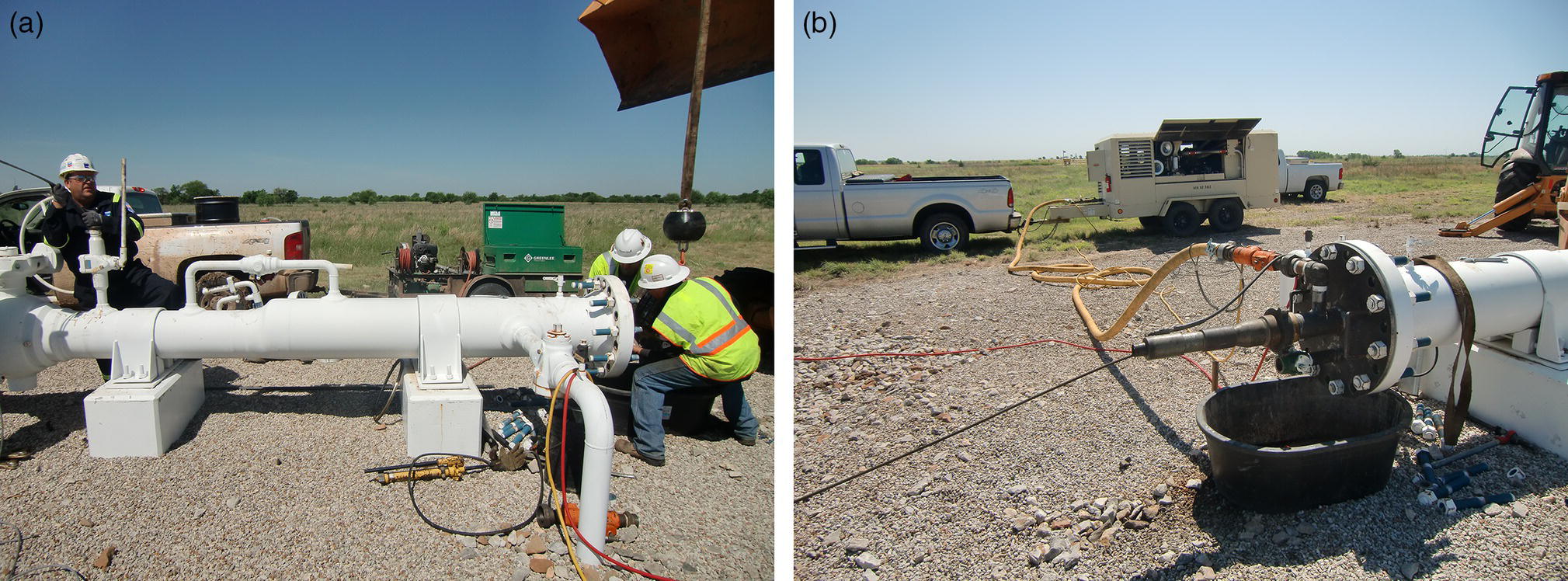 A scene features two panels labelled a and b. In panel a, a group of three workers in safety gear engage with a large pipeline system on a gravel surface under clear skies. One worker operates a control panel while another checks equipment. In panel b, a close-up view of the pipeline’s end includes a bucket and various hoses connected to machinery, with a truck parked nearby. The background reveals a vast field, highlighting an arid environment with minimal vegetation.