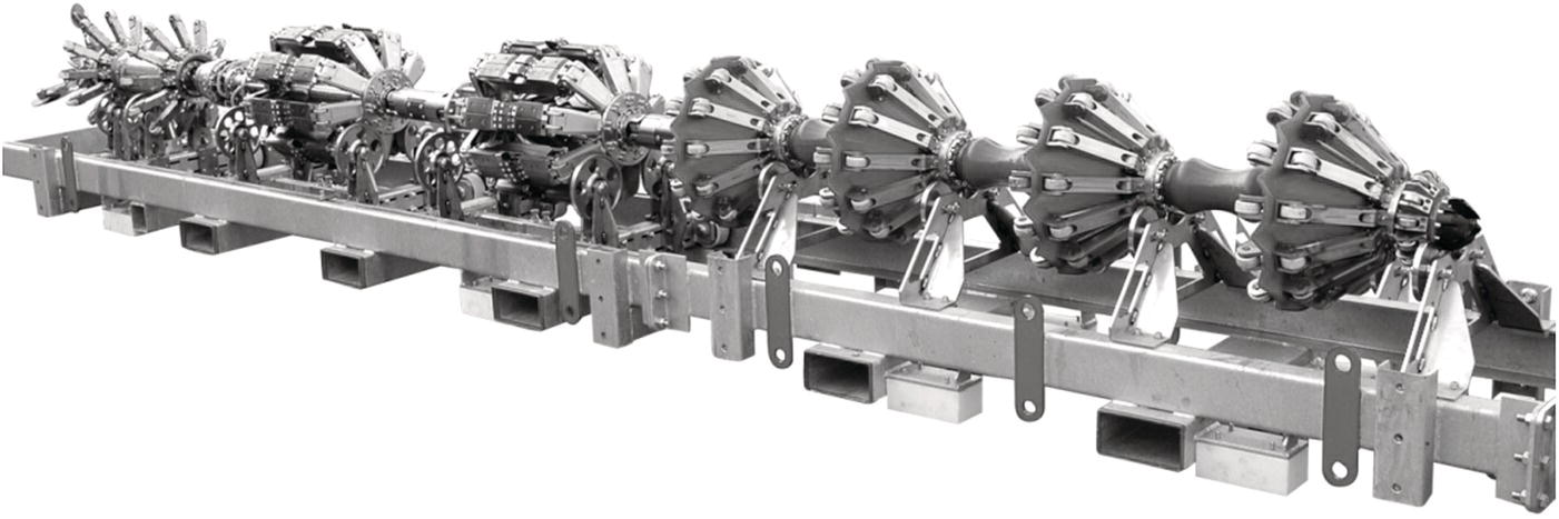 An image features a series of mechanical components arranged linearly on a metallic frame. Each component consists of a cylindrical structure with multiple radiating parts resembling propellers or vanes, suggesting a design focused on airflow or propulsion. The entire assembly has a robust, industrial appearance, likely intended for heavy-duty applications. The metallic texture and intricate connections between the components reflect engineering precision and functionality, hinting at its role in a larger machine or system, potentially in the aerospace or automotive industry.