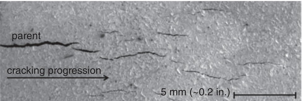 A microscopic image of longer sympathetic cracks propagating away from a parent crack.